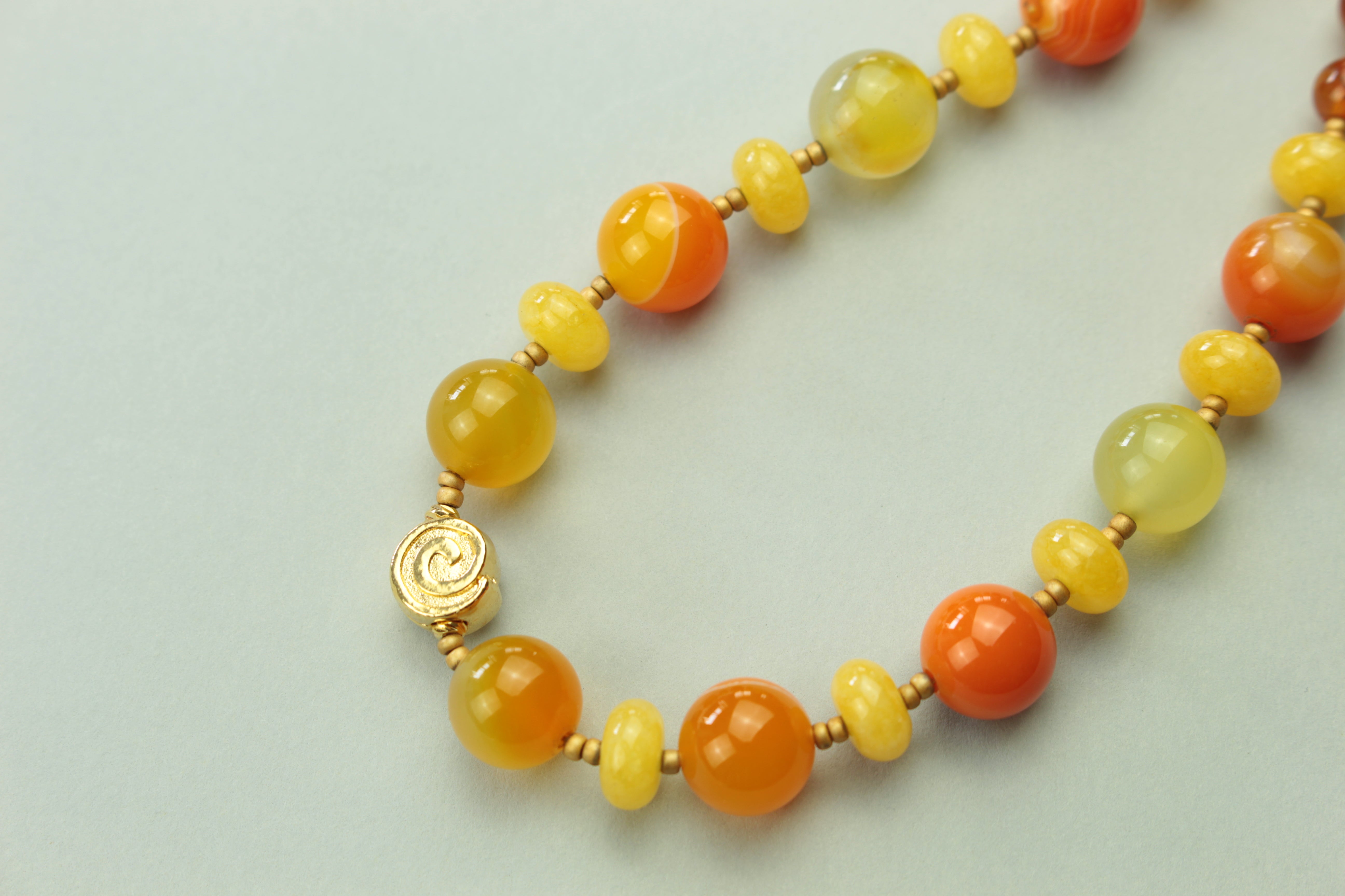 Golden sunset agate bead necklace on a warm cream background, handmade in Tauranga