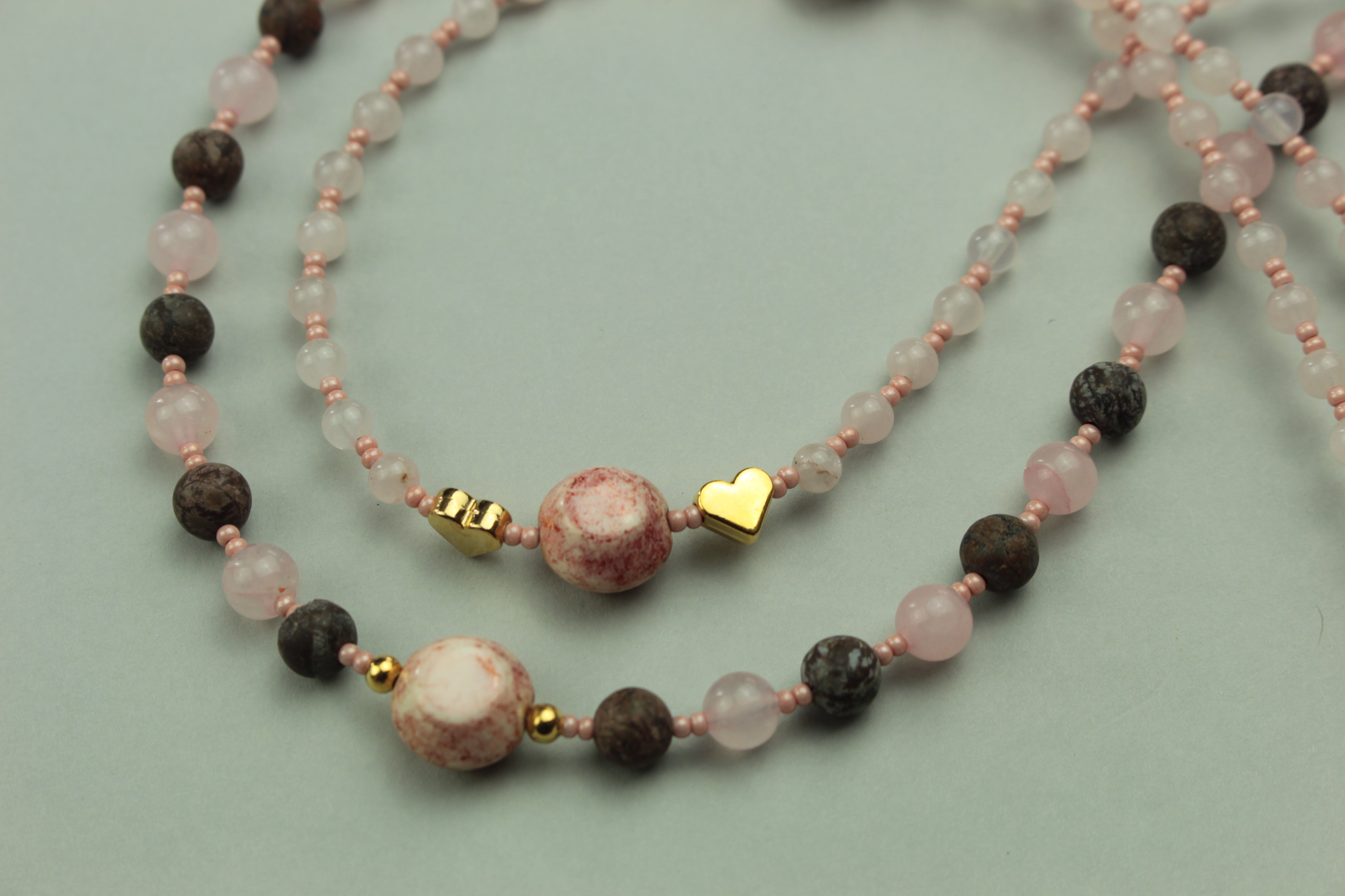 Layered rose quartz necklace on a warm cream background, handmade in Tauranga