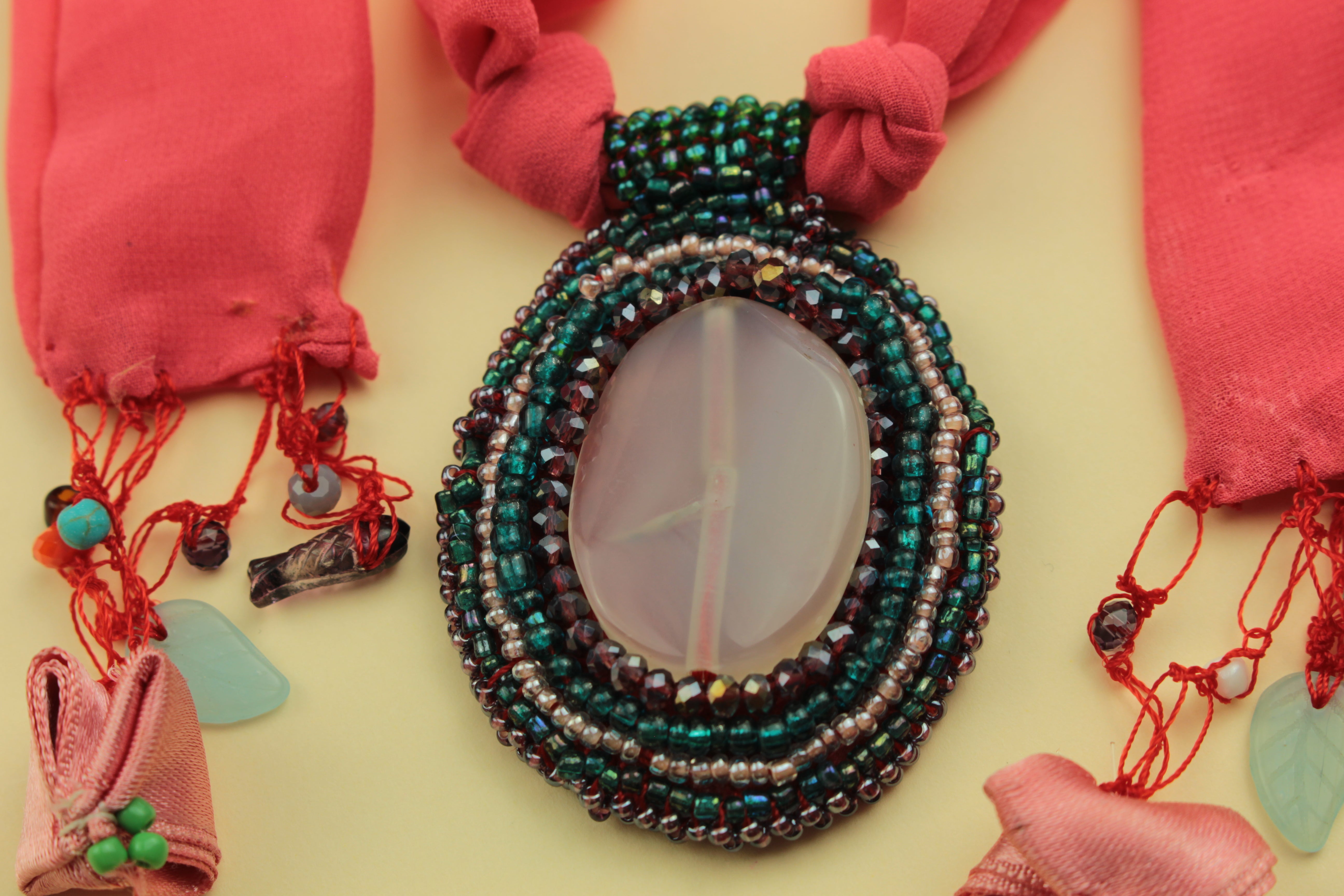 Pink aura beaded statement scarf necklace on a warm cream background, handmade in Tauranga