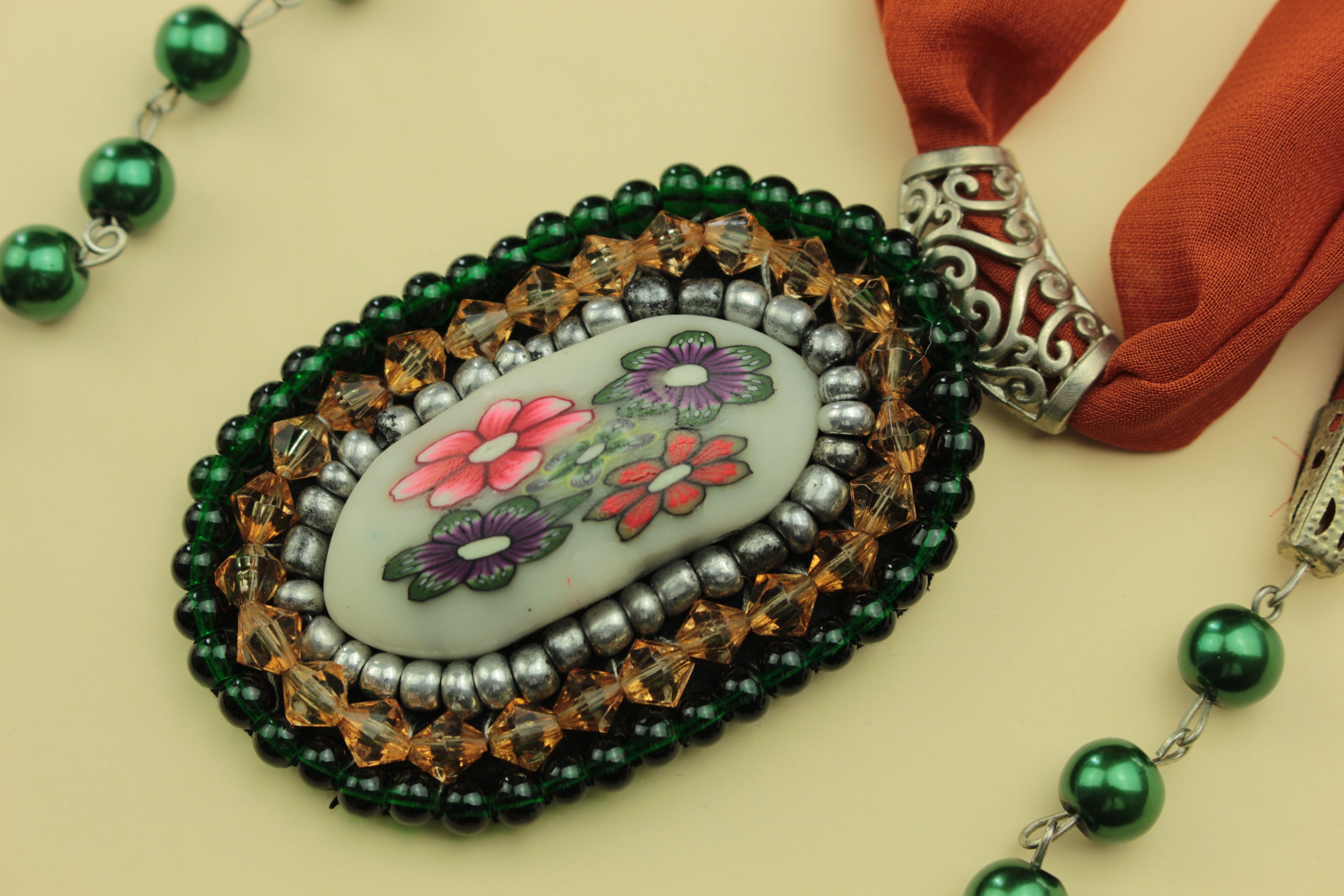 Vintage floral medallion scarf necklace on a warm cream background, handmade in Tauranga